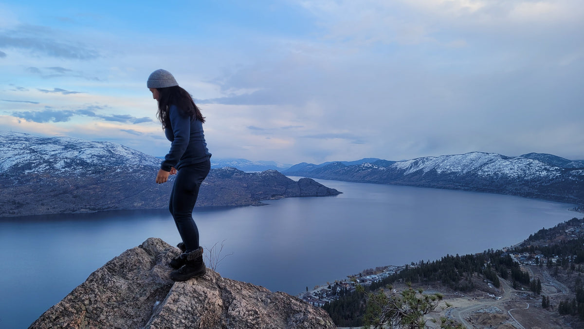 Kiyen on a rock above a lake in the mountains